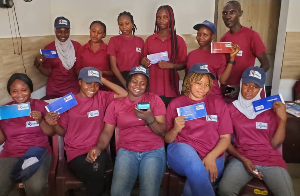 Happy Nigerian entrepreneur receiving loan approval from Rhemco